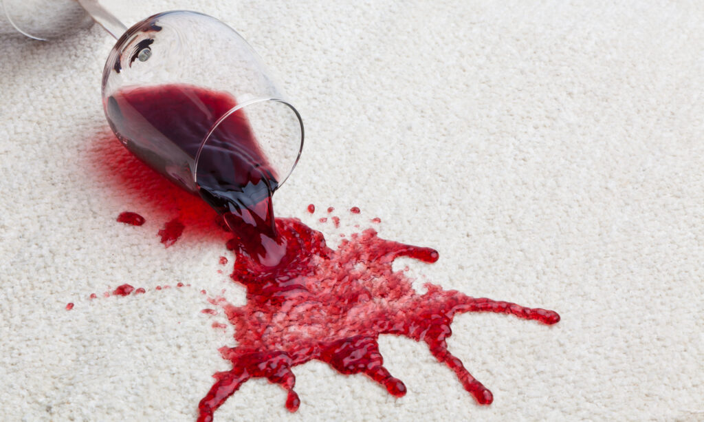 Toppled glass of red wine on carpet